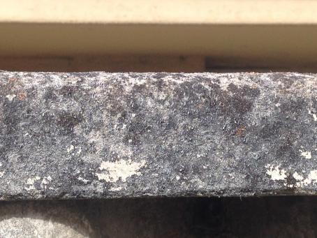 Weathered capping on an asbestos cement fence