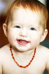 baby wearing amber teething necklace