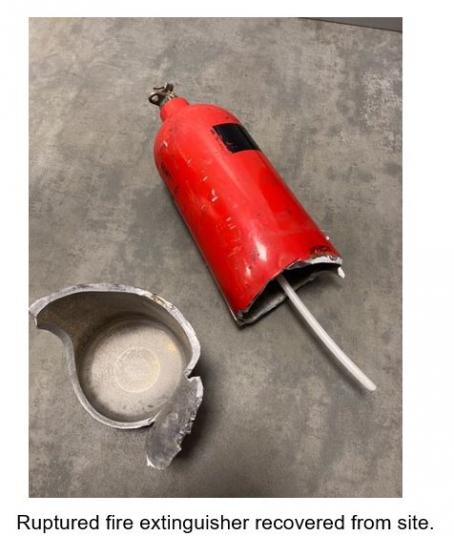 Ruptured fire extinguisher recovered from site.